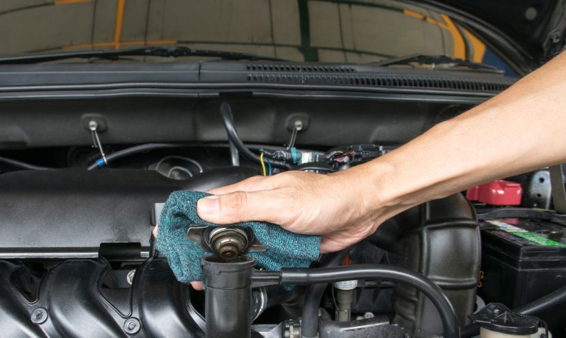 Hand open valve metal cover on a radiator for engine cooling.